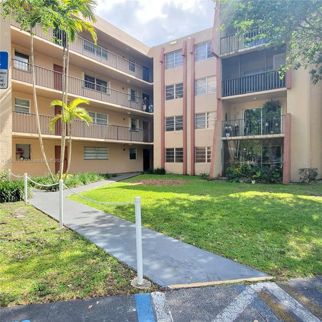 Front view of a multi-story apartment building with balconies.