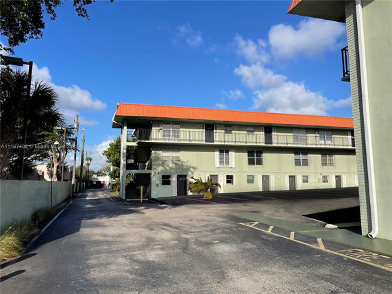 Side view of a two-story apartment building with external walkways.