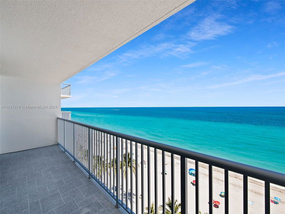 Balcony view overlooking the ocean and beach.