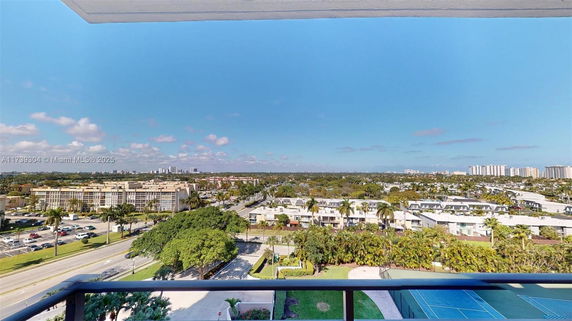 Panoramic view from a building showing surrounding landscape and residential area.
