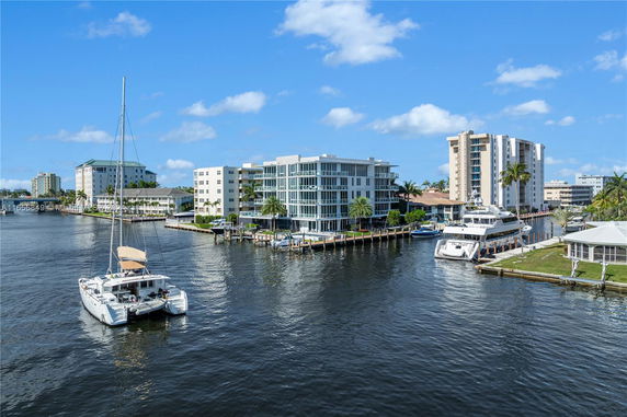 View of waterfront apartment buildings with boats docked nearby.
