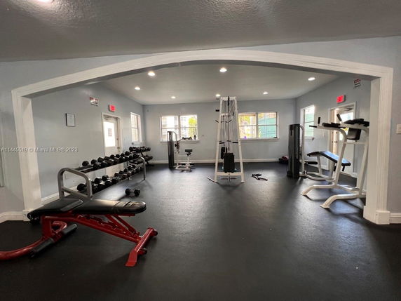 Indoor view of a gym area with exercise equipment and weights.