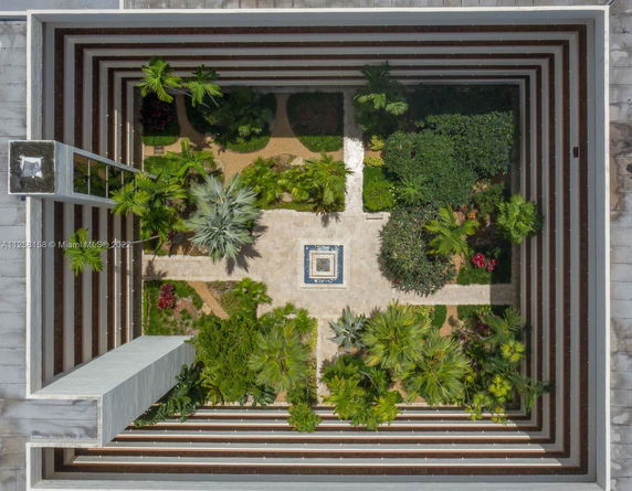 Rooftop view featuring a garden area with various plants and a decorative center.