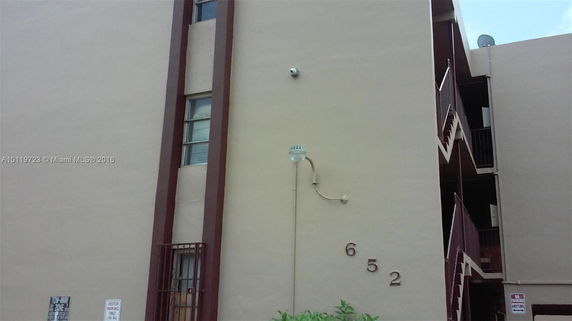 Front view of a multi-story building with exterior stairs.