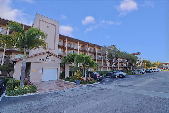 Front view of a multi-story residential building with balconies.
