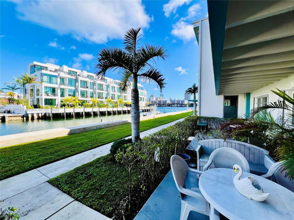 Riverside view with modern townhouses and outdoor seating area.