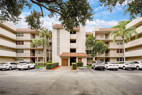 Front view of a multi-story residential building with balconies.