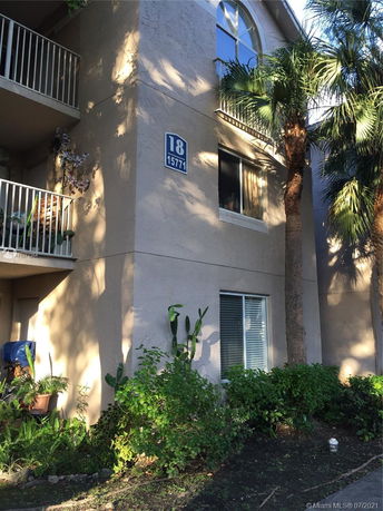 Front view of a multi-story residential building with balconies.