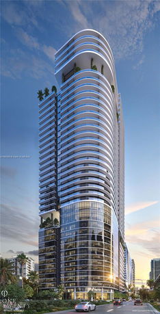Front view of a modern high-rise building with curved balconies and large glass windows.