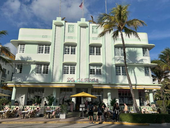 Front view of a multi-story Art Deco building with a pastel color scheme.