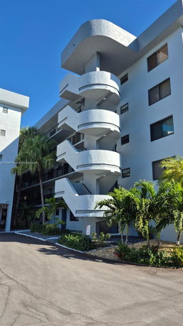 Front view of a multi-story building with external staircases.