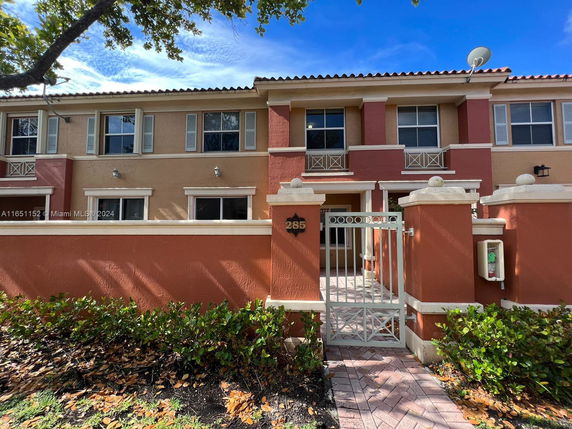 Front view of a two-story house with a gated entrance.