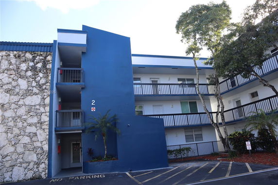 Front view of a multi-story building with blue and white exterior.