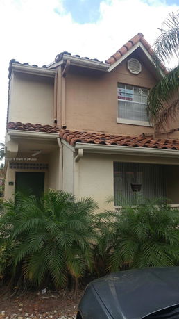 Front view of a two-story house with tile roofing.