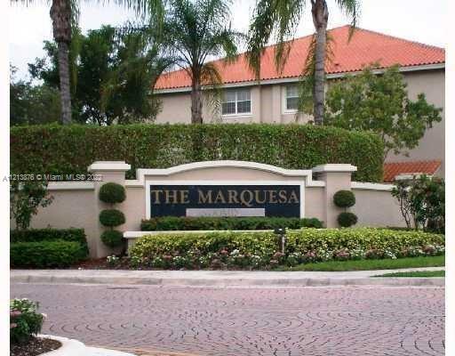 Front elevation view of a residential building with a sign reading 'The Marquesa'.