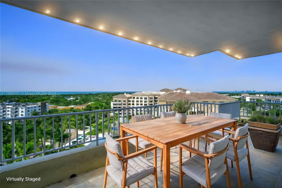 Panoramic view of surrounding area from a balcony with outdoor furniture.