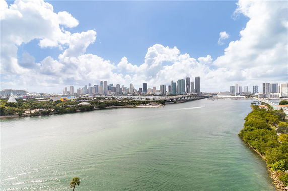 Panoramic view of water body with a city skyline in the background.