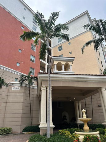 Front view of a multi-story residential building with colorful exterior walls and a decorative entrance.