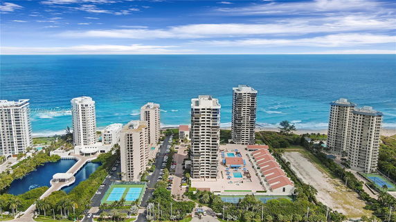 Aerial view of a coastal area with tall residential buildings near the ocean.