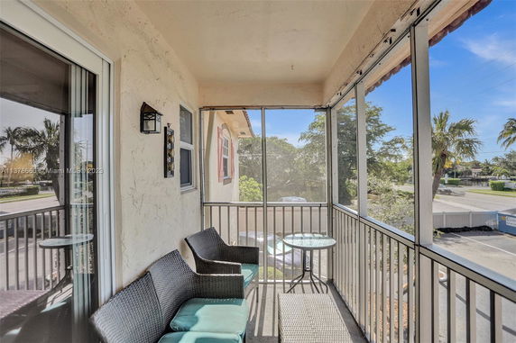 Balcony view from a building showing outdoor surrounding area.