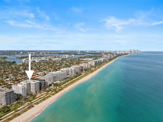 Aerial view of beachfront buildings along a coastline.