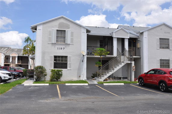 Front view of a two-story building with external stairs.