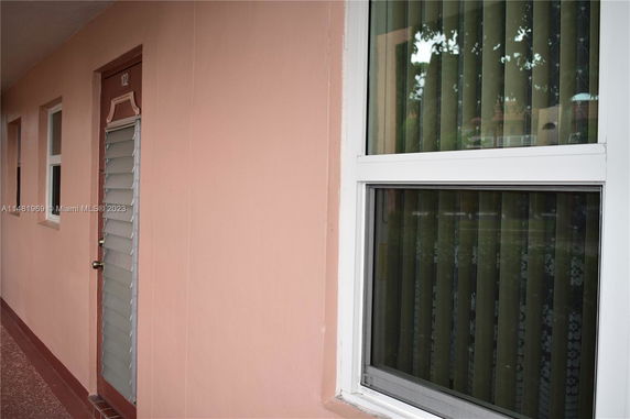 View of a building exterior with a door and window.