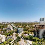 Wide-angle view of a cityscape with multiple buildings and roads extending into the distance.