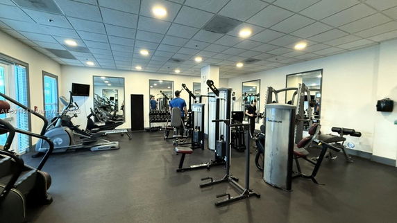 Interior view of a gym with various exercise equipment.