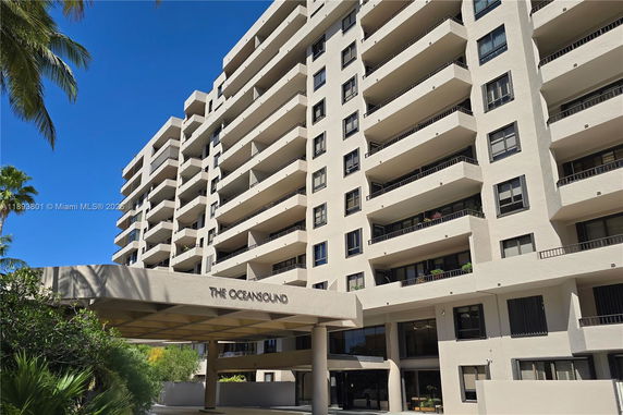 Front view of a multi-story residential building with balconies.