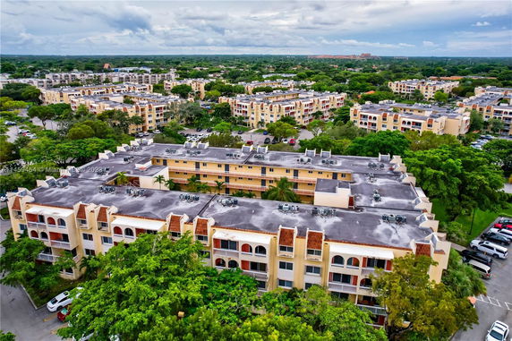 Aerial view of multiple residential buildings surrounded by greenery.