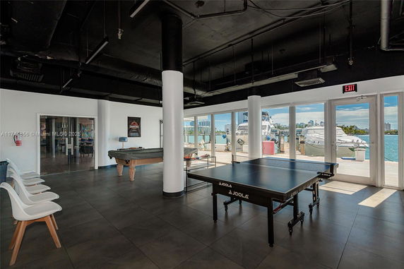 Indoor recreational area with a billiards table and table tennis setup.