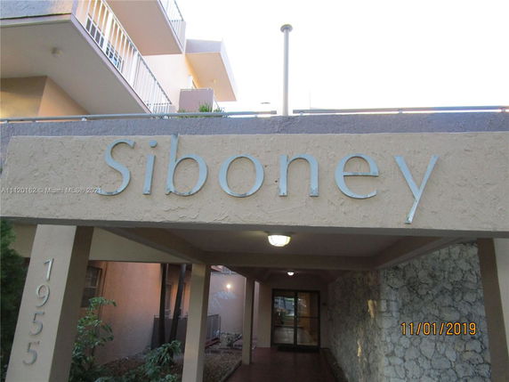 Front view of a multi-story building with balconies and an entrance labeled 'Siboney'.
