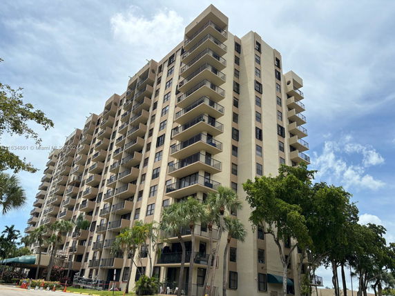 Front view of a multi-story residential building with balconies.