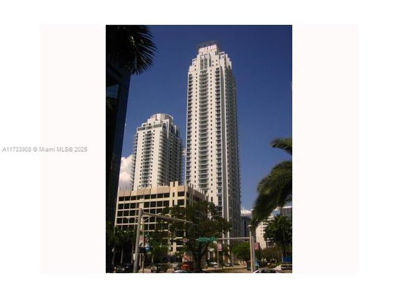 Front view of a tall high-rise building in a city.