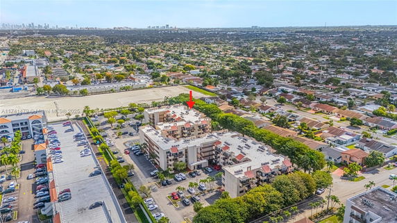 Aerial view of apartment buildings with rooftops and surrounding residential area.