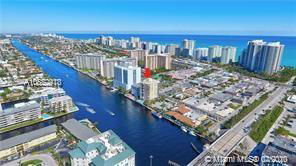 Panoramic view of coastal cityscape with waterways and high-rise buildings.