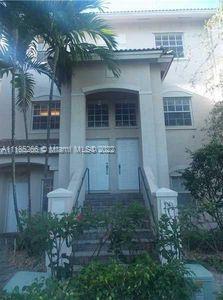 Front view of a multi-story house with a columned entrance.