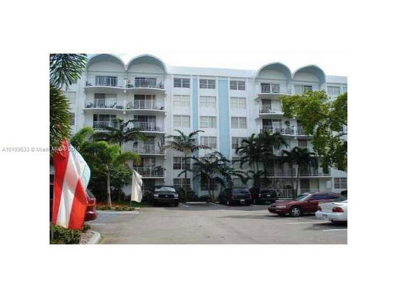 Front view of a multi-story residential building with balconies.