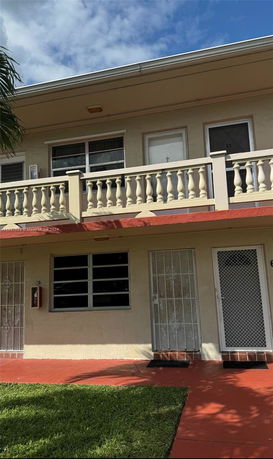 Front view of a two-story building with a balcony.