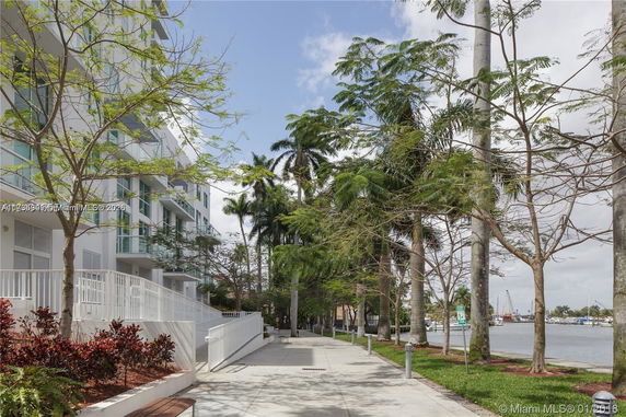 Side view of a multi-story residential building with balconies.
