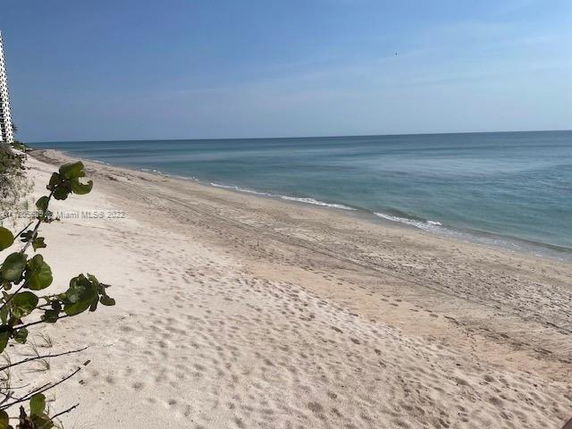 View of a sandy beach and ocean.