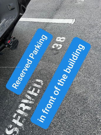 Reserved parking space marked with the number 38 on an asphalt surface.