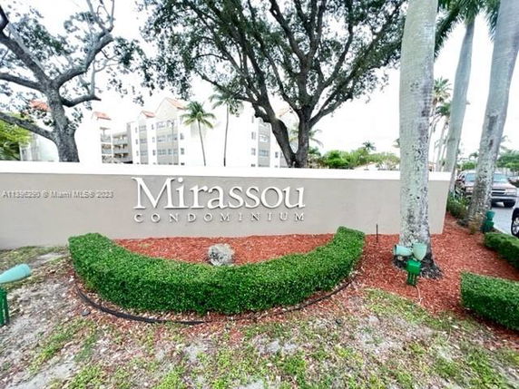 Front view of a condominium building with a sign that reads 'Mirassou Condominium'.
