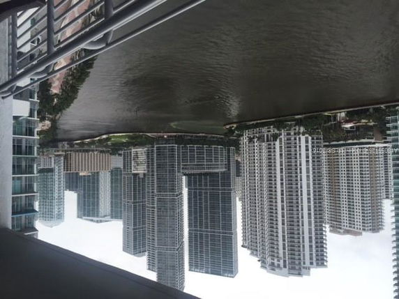 Panoramic view of high-rise buildings along a waterfront.
