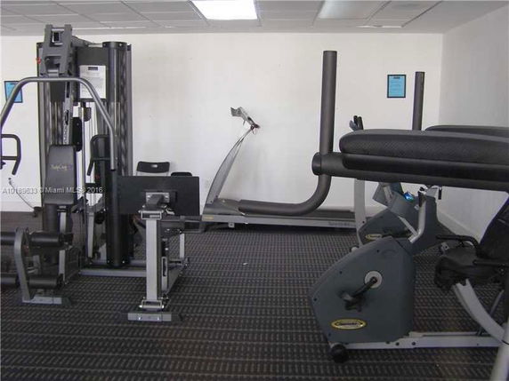 Indoor gym area featuring exercise machines including a treadmill and stationary bike.