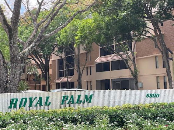 Front view of a multi-story residential building named Royal Palm.