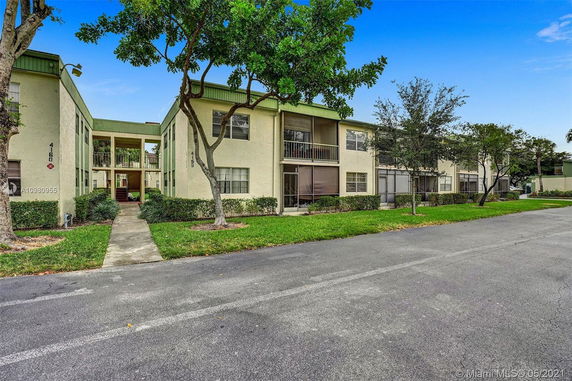 Front view of a two-story apartment building with balconies.