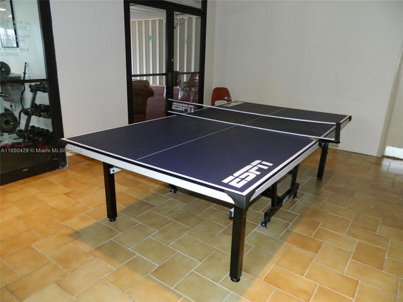 Indoor table tennis setup in a recreational space.