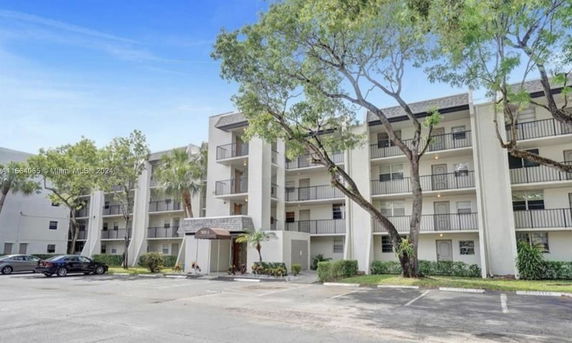 Front view of a multi-story apartment building with balconies.